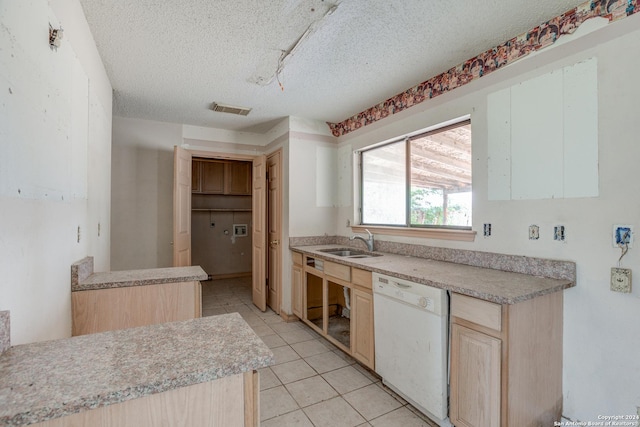 kitchen featuring a textured ceiling, dishwasher, sink, and light brown cabinetry