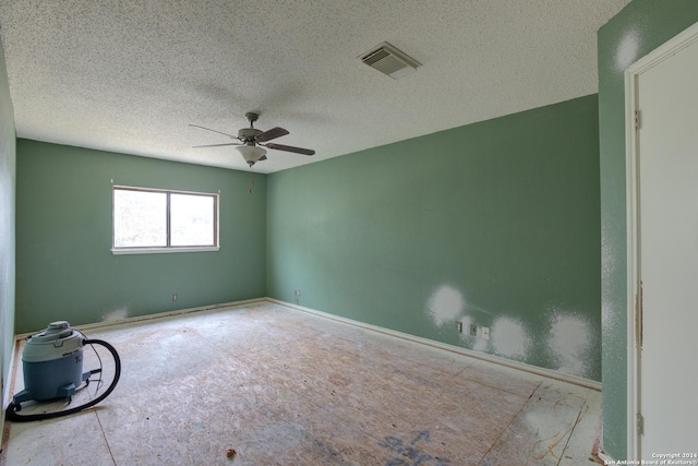 spare room with ceiling fan and a textured ceiling