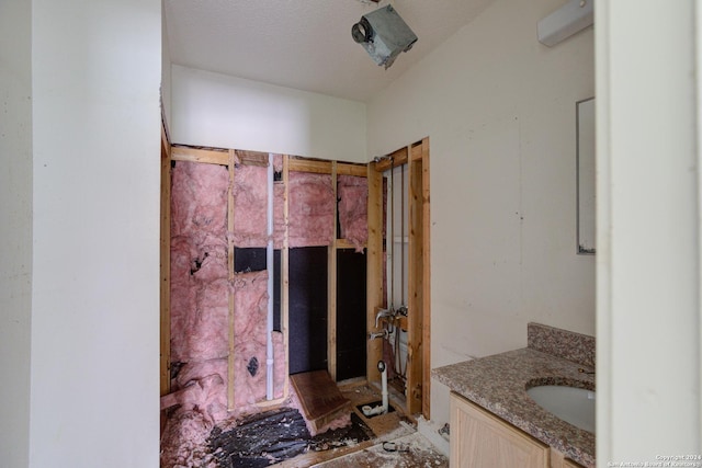 bathroom featuring vanity and a textured ceiling