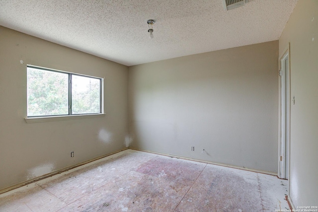 empty room featuring a textured ceiling