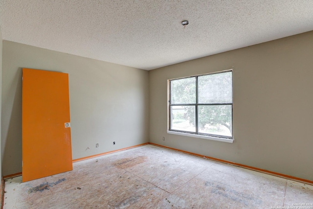 empty room featuring a textured ceiling