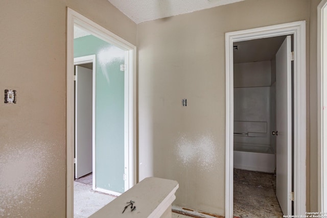 corridor featuring a textured ceiling