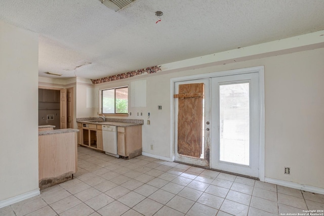 kitchen with dishwasher, light tile patterned floors, a textured ceiling, and french doors