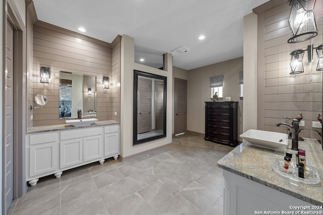 full bath with visible vents, a sink, recessed lighting, and two vanities