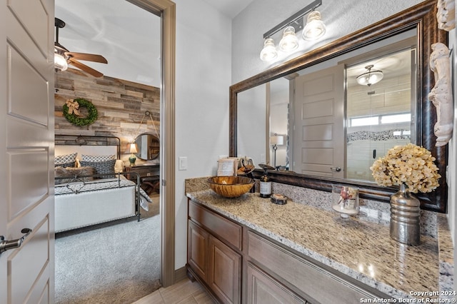 bathroom with vanity, ceiling fan, and wooden walls