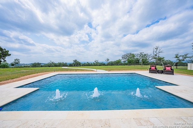 outdoor pool with a patio, fence, and a lawn