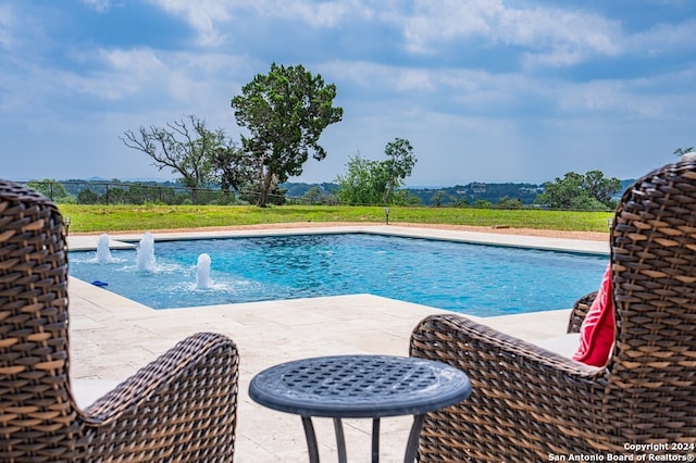 pool featuring fence and a patio area