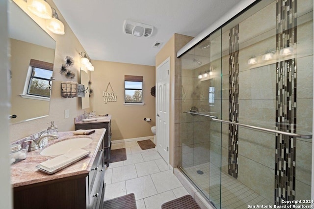 bathroom featuring tile patterned floors, a shower with shower door, toilet, and vanity