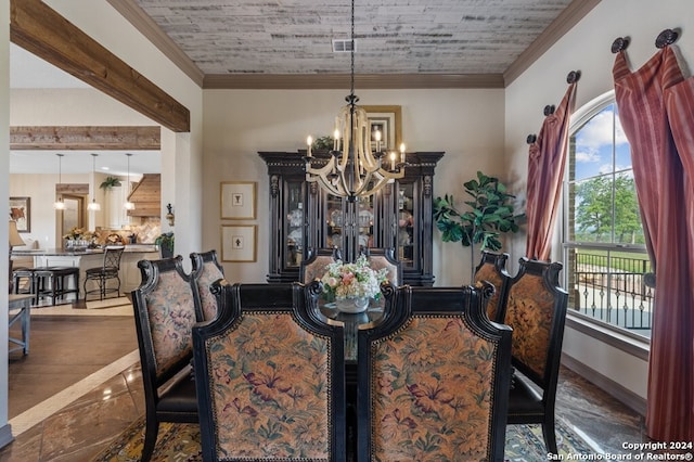 dining area with crown molding, a notable chandelier, and hardwood / wood-style floors