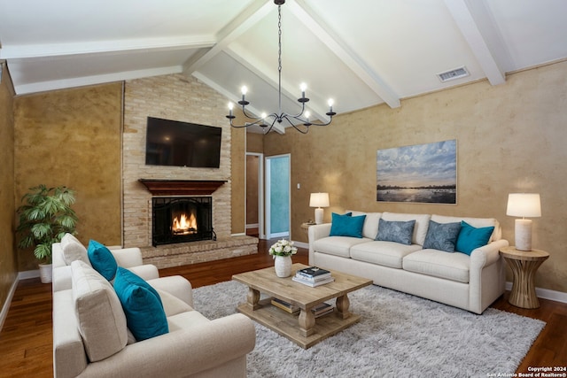 living room featuring hardwood / wood-style flooring, lofted ceiling with beams, a fireplace, and a chandelier