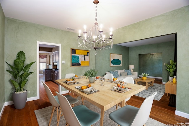 dining space with a chandelier and wood-type flooring