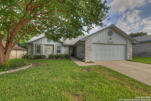 ranch-style home with a front lawn and a garage