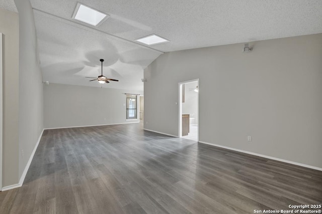 spare room with a textured ceiling, ceiling fan, dark hardwood / wood-style floors, and lofted ceiling