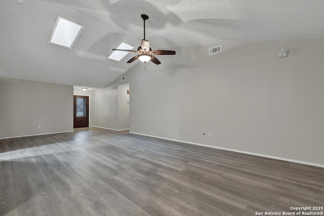 empty room featuring vaulted ceiling, ceiling fan, and dark wood-type flooring