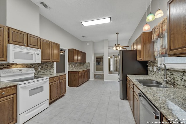 kitchen with ceiling fan, sink, decorative light fixtures, decorative backsplash, and appliances with stainless steel finishes