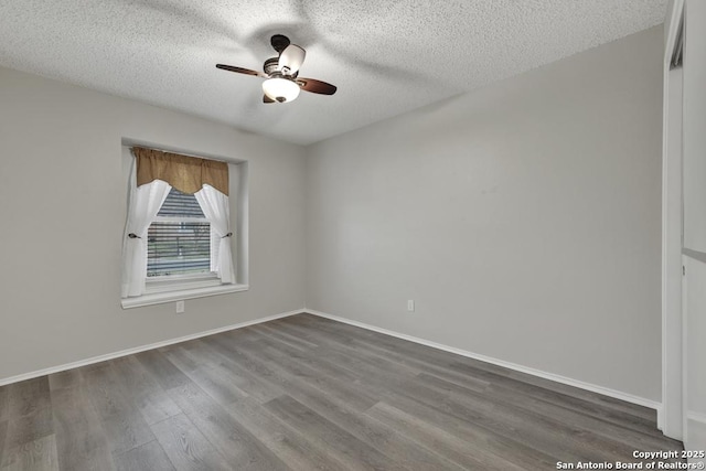 unfurnished room with ceiling fan, a textured ceiling, and dark wood-type flooring