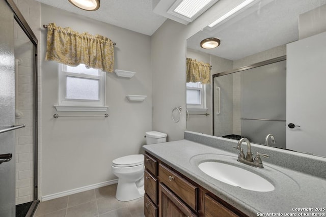 bathroom with a wealth of natural light, vanity, an enclosed shower, and toilet