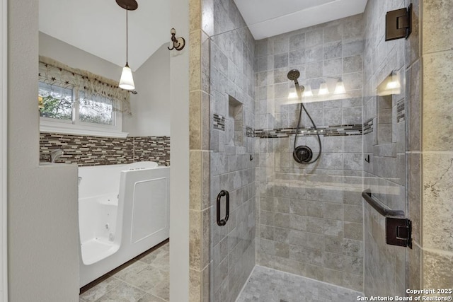 bathroom with walk in shower and lofted ceiling