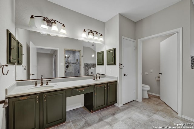 bathroom featuring vanity, toilet, and an enclosed shower