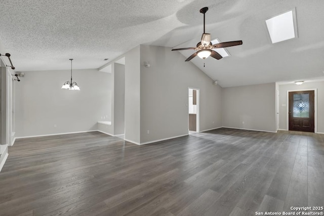 unfurnished living room featuring ceiling fan with notable chandelier, dark hardwood / wood-style flooring, and vaulted ceiling