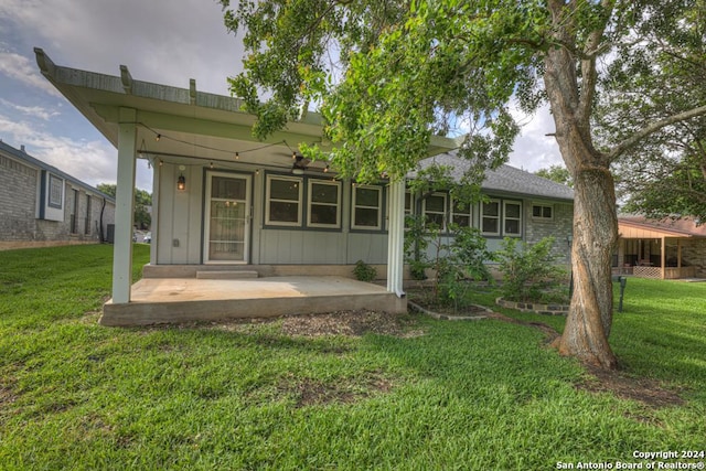 back of house with a lawn