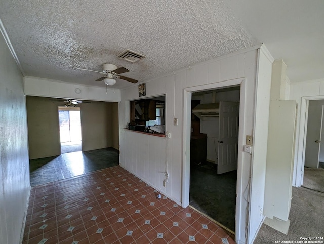 unfurnished room featuring a textured ceiling and ceiling fan