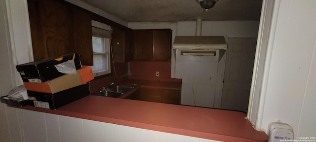 kitchen with sink and a textured ceiling