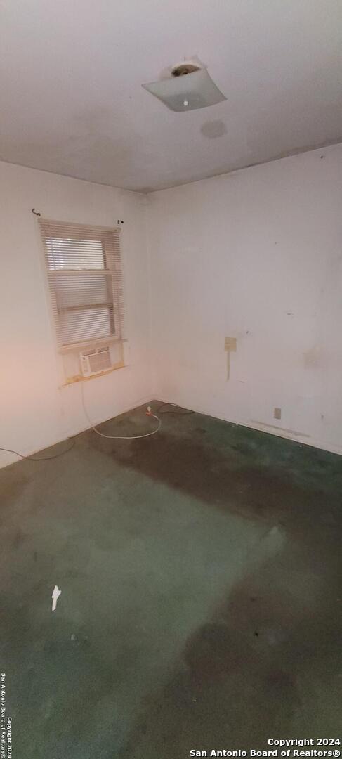 empty room with carpet and cooling unit