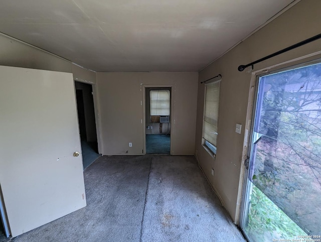 empty room with cooling unit and carpet floors