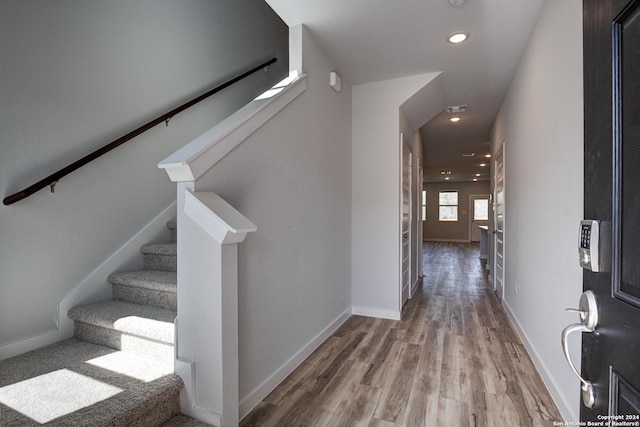 staircase with hardwood / wood-style flooring