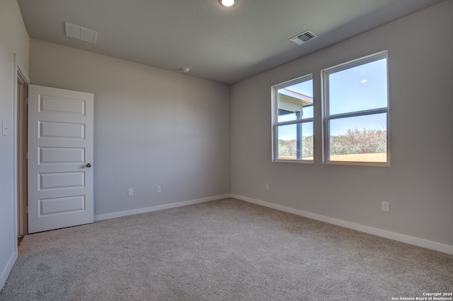 empty room with light colored carpet