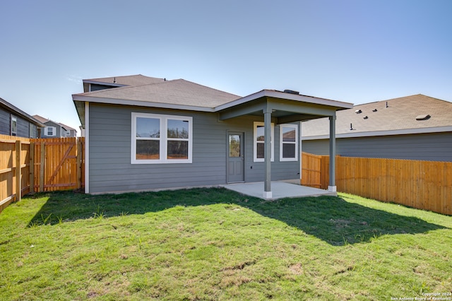 rear view of house with a yard and a patio area