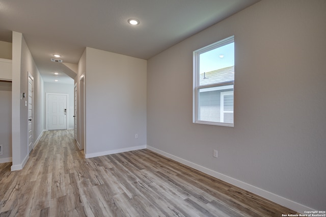 unfurnished room with light wood-type flooring