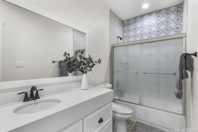 full bathroom with vanity, toilet, and enclosed tub / shower combo