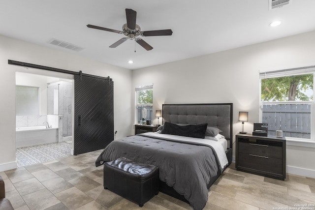 bedroom with a barn door and ceiling fan