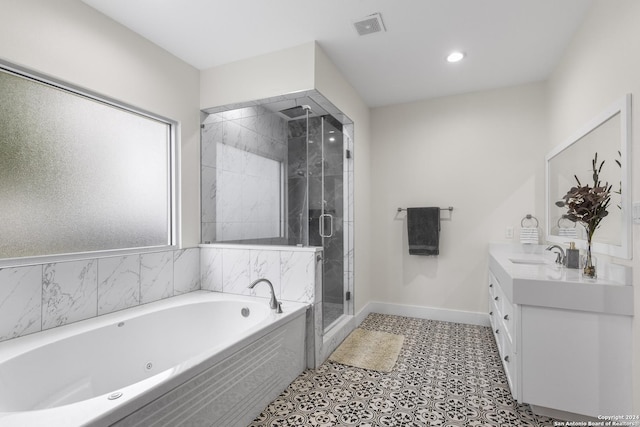 bathroom featuring vanity and separate shower and tub