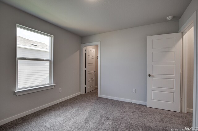 unfurnished bedroom featuring light colored carpet