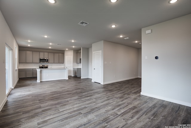 unfurnished living room with dark hardwood / wood-style flooring