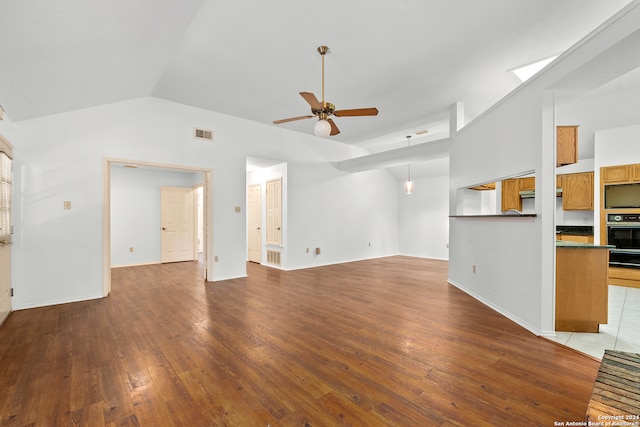 unfurnished living room featuring ceiling fan, hardwood / wood-style flooring, and lofted ceiling