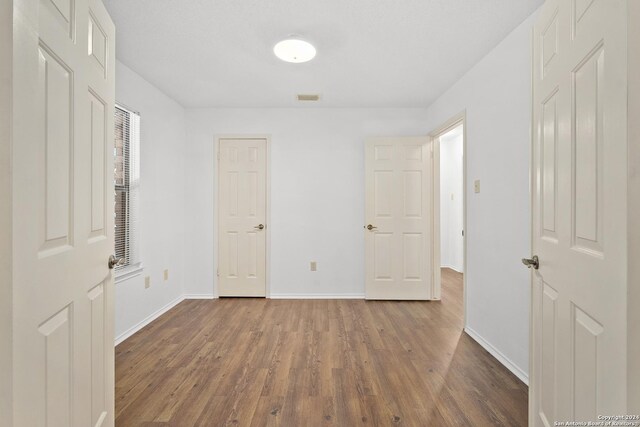 unfurnished room featuring wood-type flooring