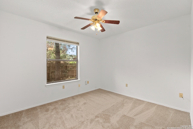 spare room with carpet floors and ceiling fan