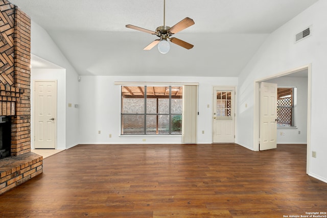 unfurnished living room with a brick fireplace, dark hardwood / wood-style flooring, ceiling fan, high vaulted ceiling, and a textured ceiling