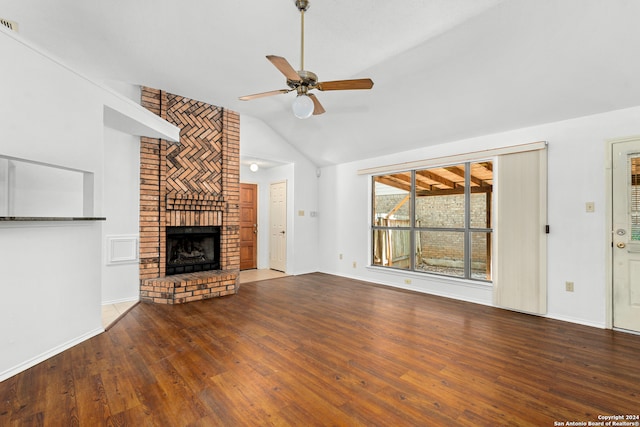 unfurnished living room featuring a brick fireplace, dark hardwood / wood-style flooring, ceiling fan, and lofted ceiling