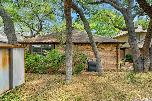 view of side of home with central AC