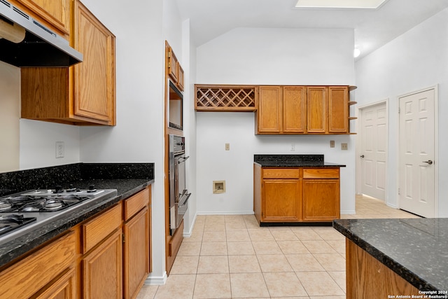 kitchen featuring high vaulted ceiling, oven, dark stone countertops, and light tile floors