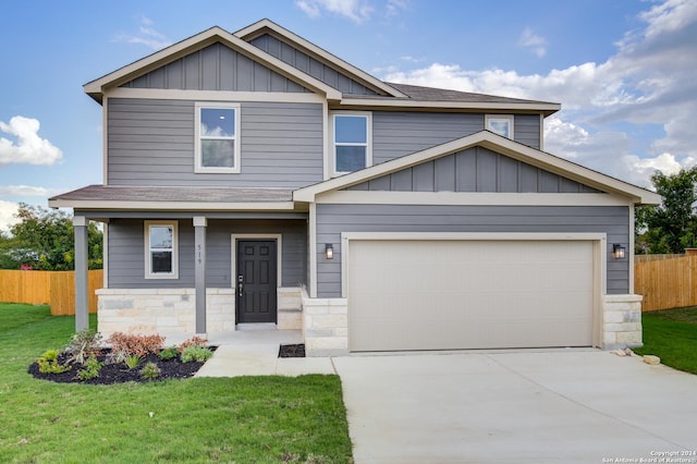 craftsman-style home featuring a front lawn and a garage