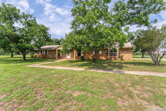 ranch-style home with a front lawn