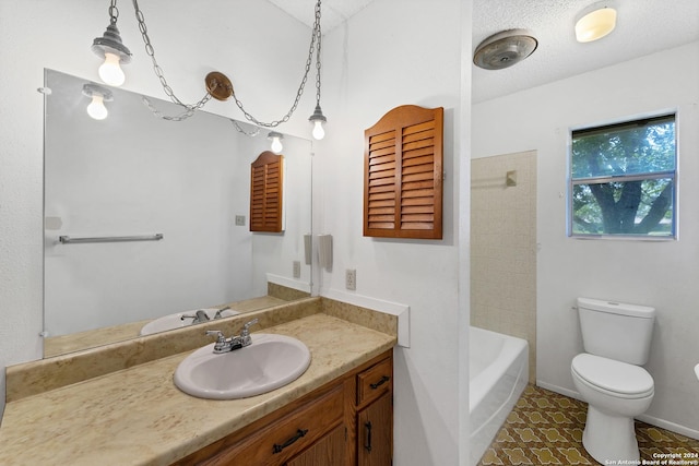 bathroom with tile patterned floors, vanity, toilet, and a textured ceiling