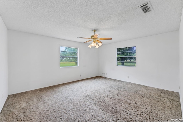 spare room with carpet flooring, a textured ceiling, and ceiling fan