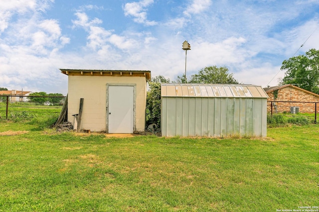 view of outbuilding with a lawn